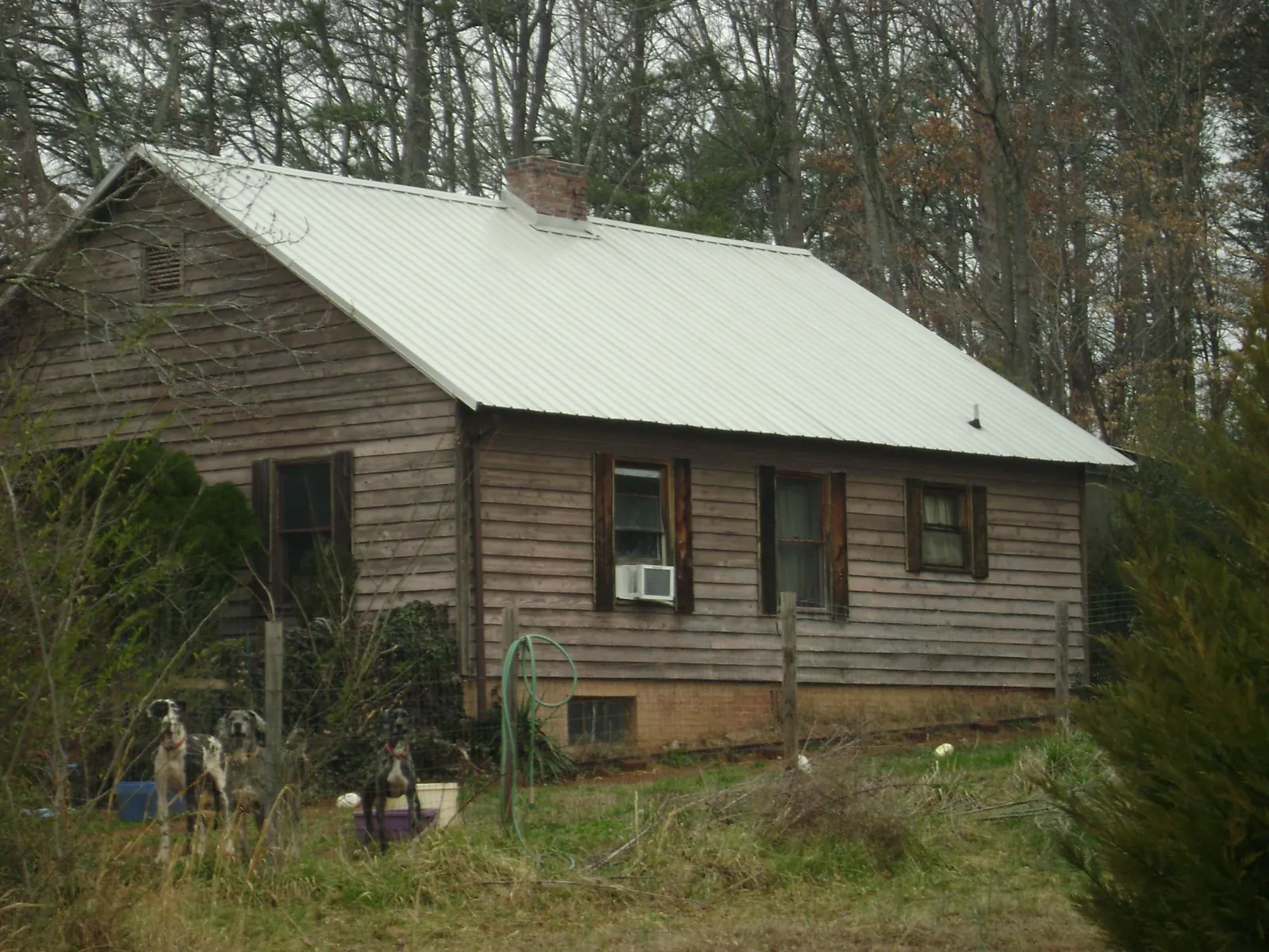 White metal roof on an old wood sided farmhouse, from a Metal Roof Installation job in Philipsburg